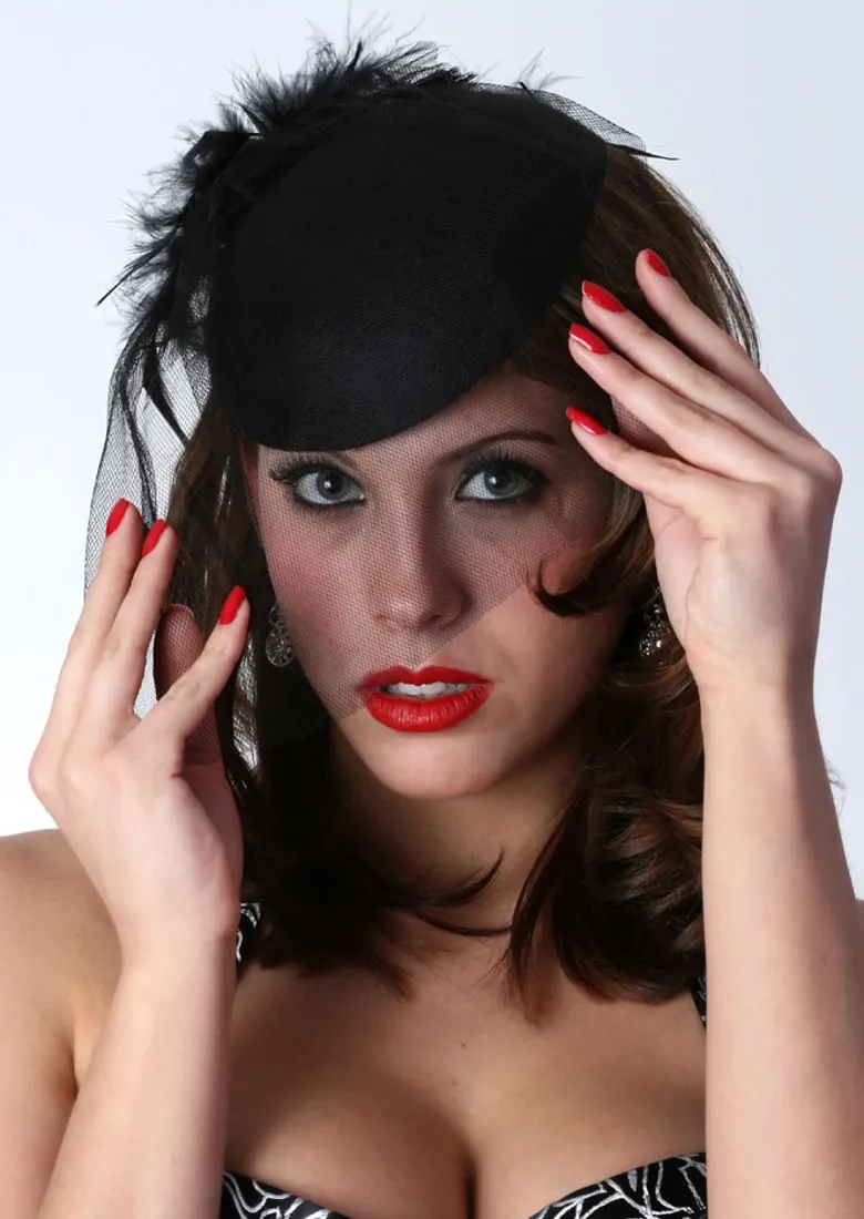 A studio fashion portrait of a woman in a black hat